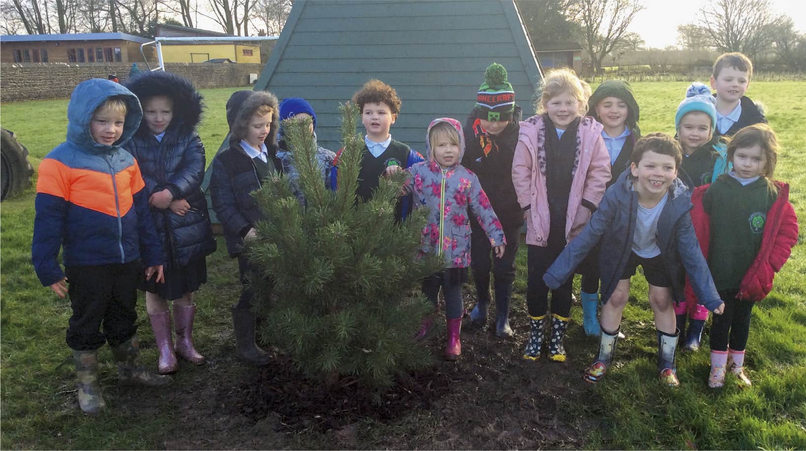 2. Pilling St Johns Primary. Happy faces beside their Pinus sylvestris, 2022. (Photo: Pilling St Johns Primary School)