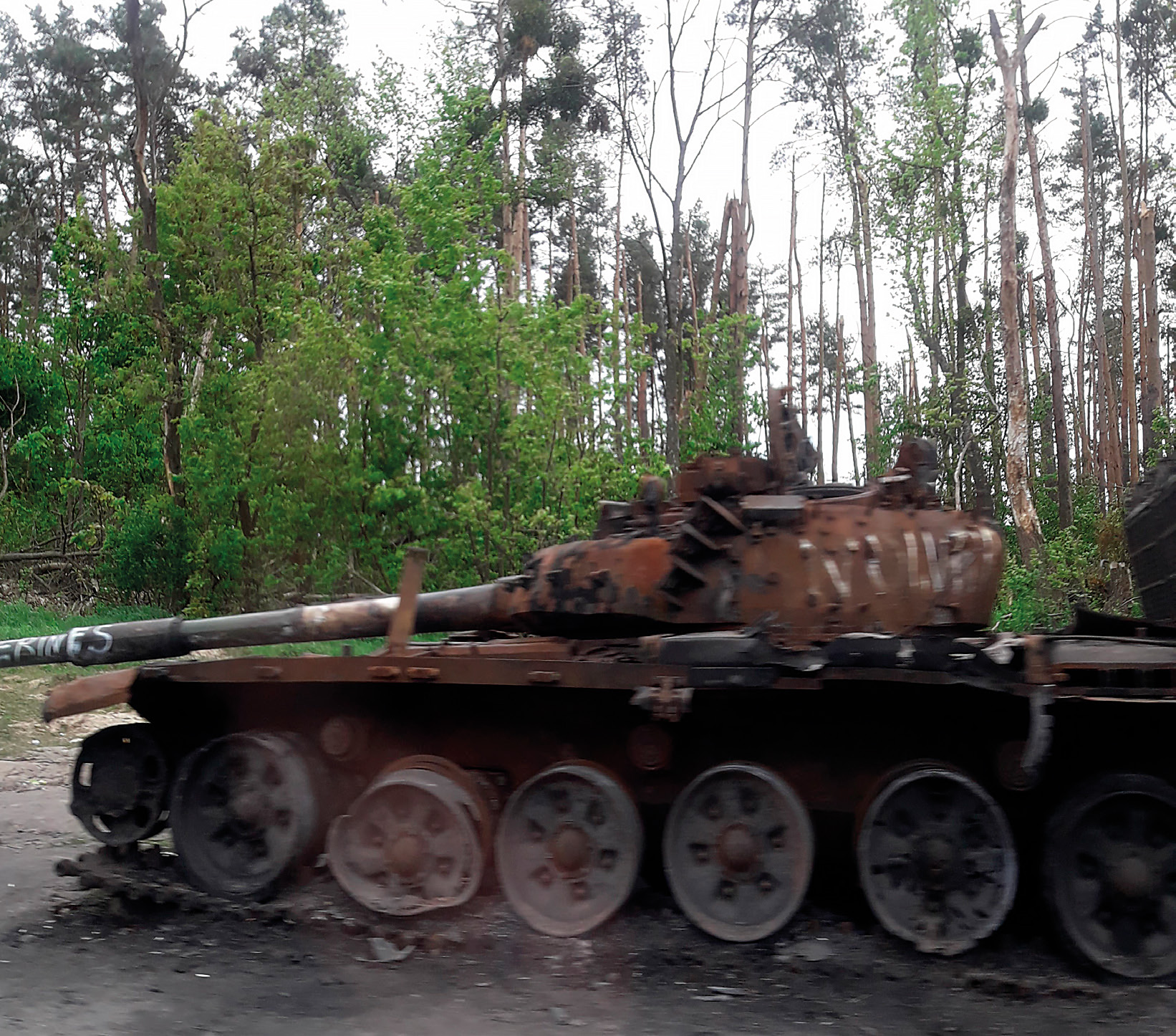 Figure 1: Burnt-out Russian tank and evidence of leaked fluids (gasoline, but also toxic remnants of ammunition, brake fluid and hydraulic fluids) that can contaminate a landscaped area.