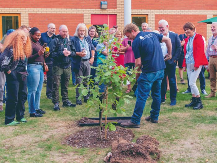 John Parker plants a young tree at the tree planting ceremony at the What is a Tree? conference